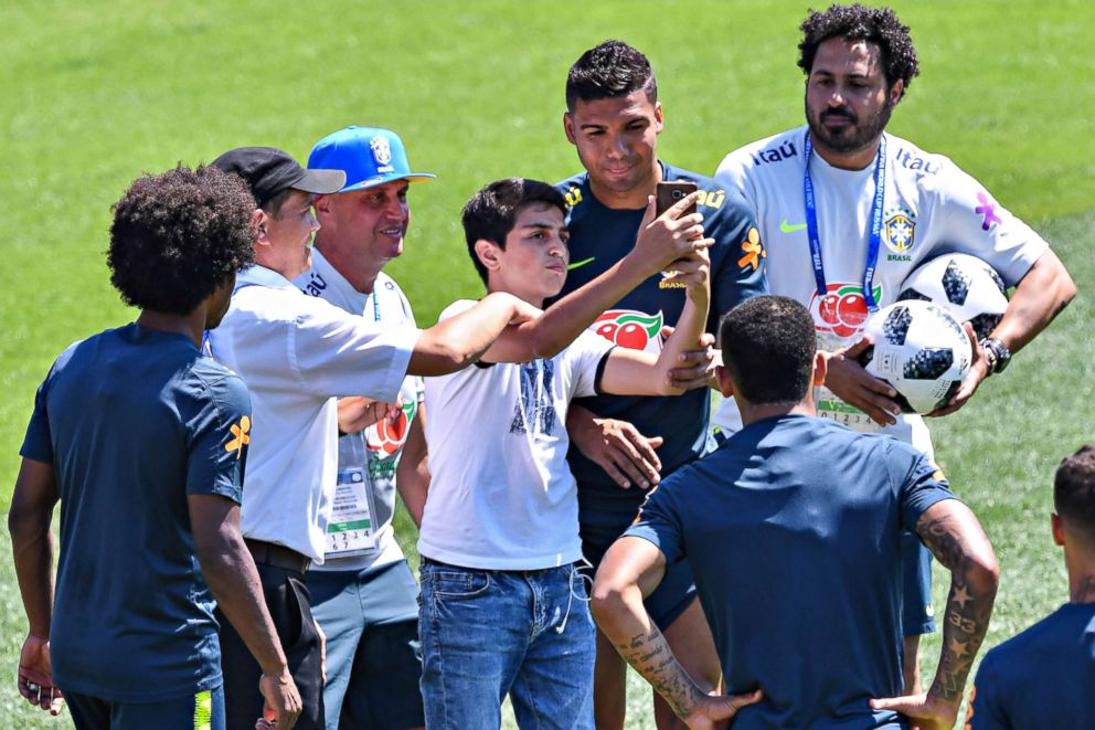 PHOTO: A fan takes a picture with Brazils Casemiro during a training session at Sochi Municipal Stadium in Sochi, Russia on June 12, 2018, ahead of the Russia 2018 World Cup.