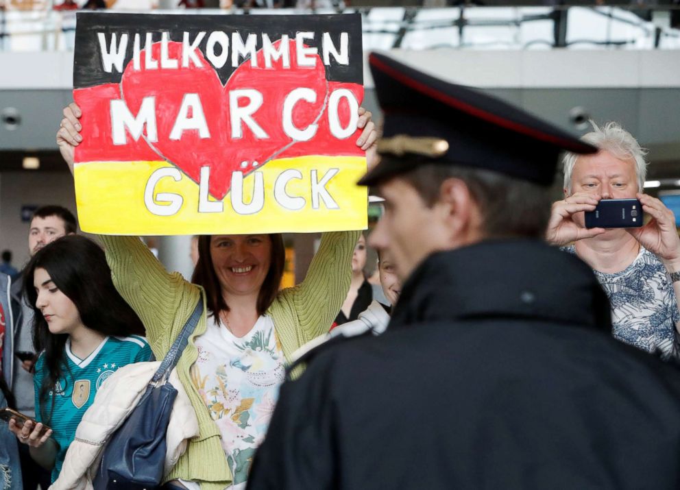 PHOTO: A Germany fan greets players as they arrive at Vnukovo International Airport for the World Cup on June 12, 2018, in Moscow.
