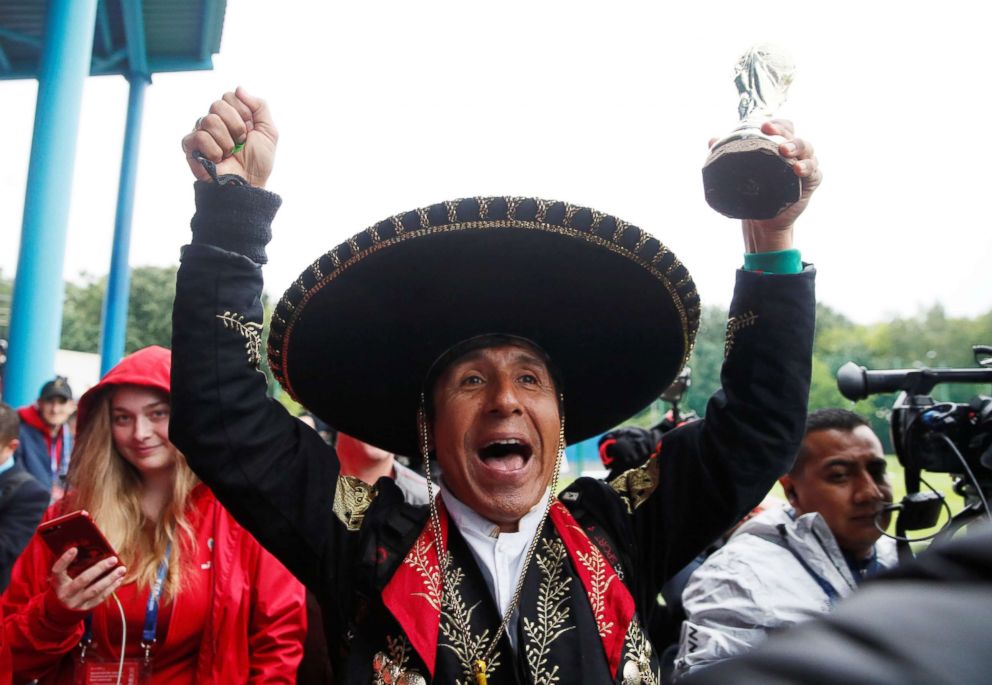 PHOTO: A Mexico fan holds a toy trophy at FC Strogino Stadium on June 12, 2018, ahead of the of the World Cup in Moscow.