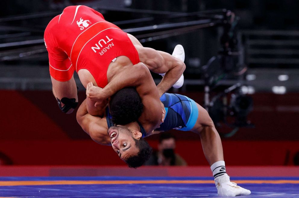 PHOTO: Tunisia's Souleymen Nasr wrestles Refugee Olympic Team's Aker Al Obaidi in their men's greco-roman 67kg wrestling early round match during the Tokyo 2020 Olympic Games at the Makuhari Messe in Tokyo on Aug. 3, 2021.