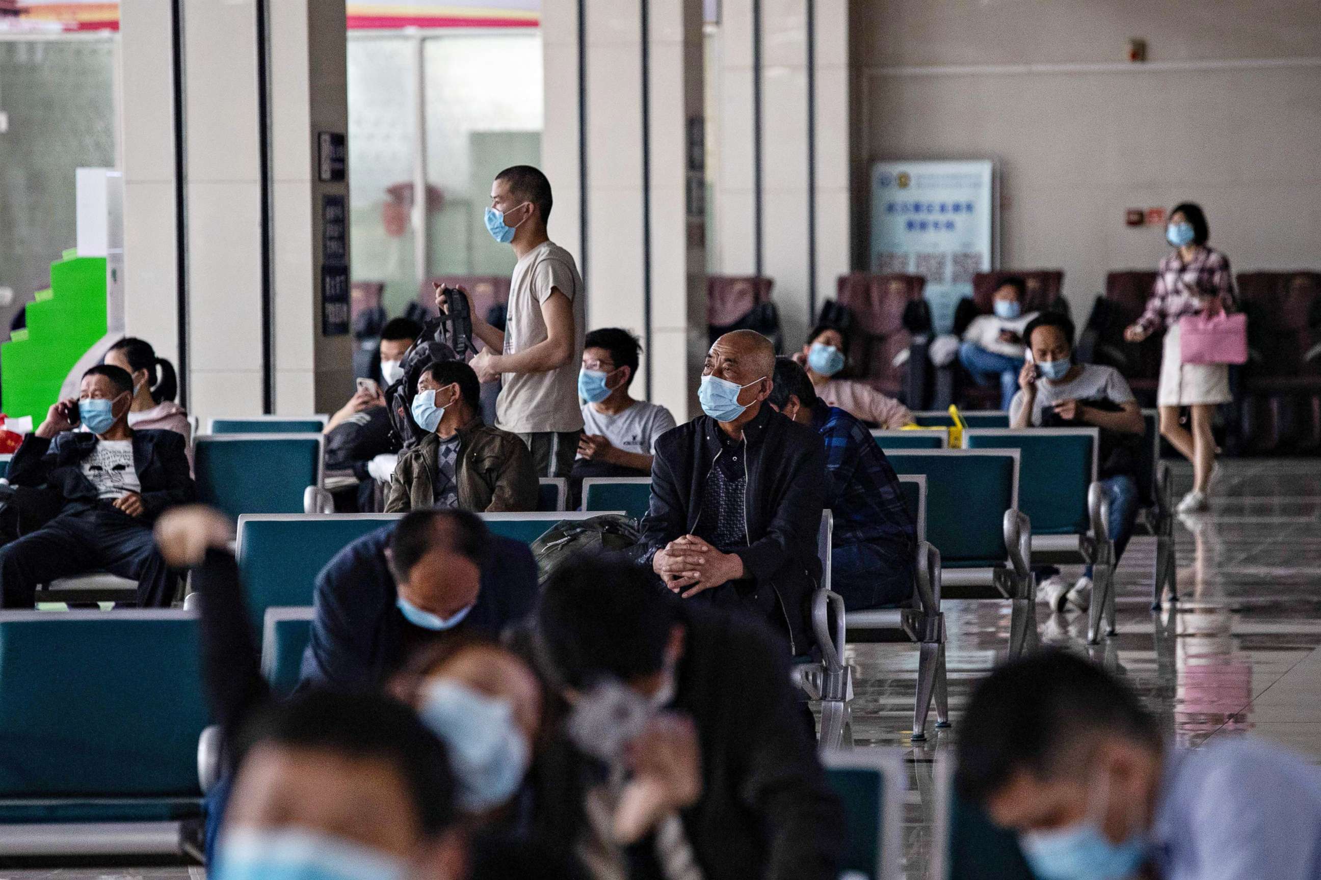 PHOTO: Passengers wait at a long-distance bus station in Wuhan in China's central Hubei province, on April 30, 2020, ahead of the Labor Day holiday which starts on May 1.