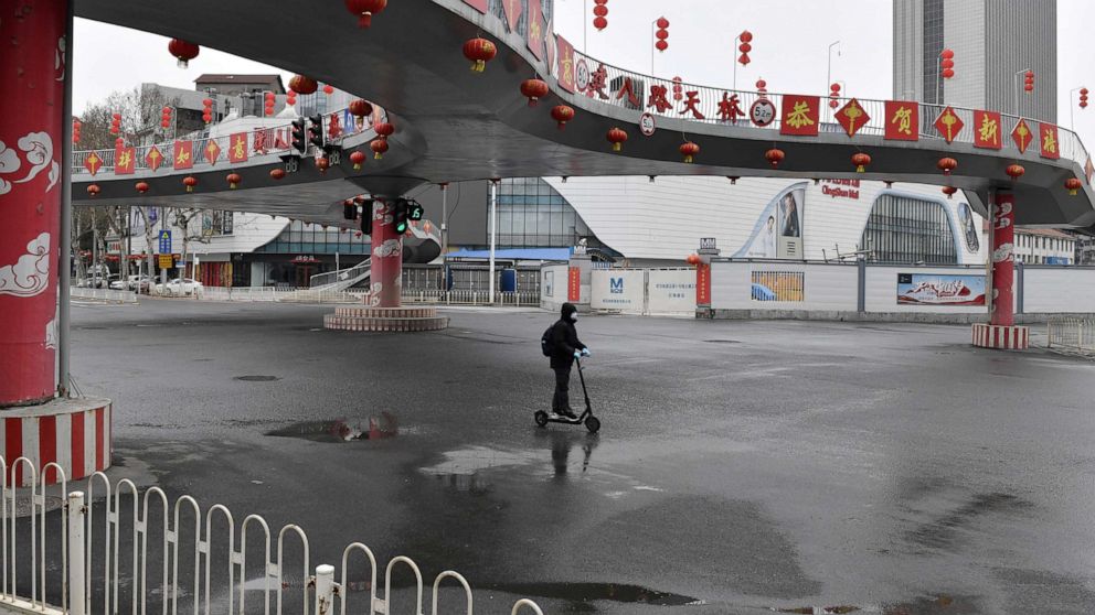PHOTO: A man wearing a face mask rides a kick scooter through an intersection in Wuhan, the epicentre of the novel coronavirus outbreak, Hubei province, China March 3, 2020.