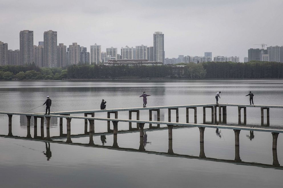 PHOTO: Residents wearing face masks play inside the East Lake, March 30, 2020 in Hubei Province, China.