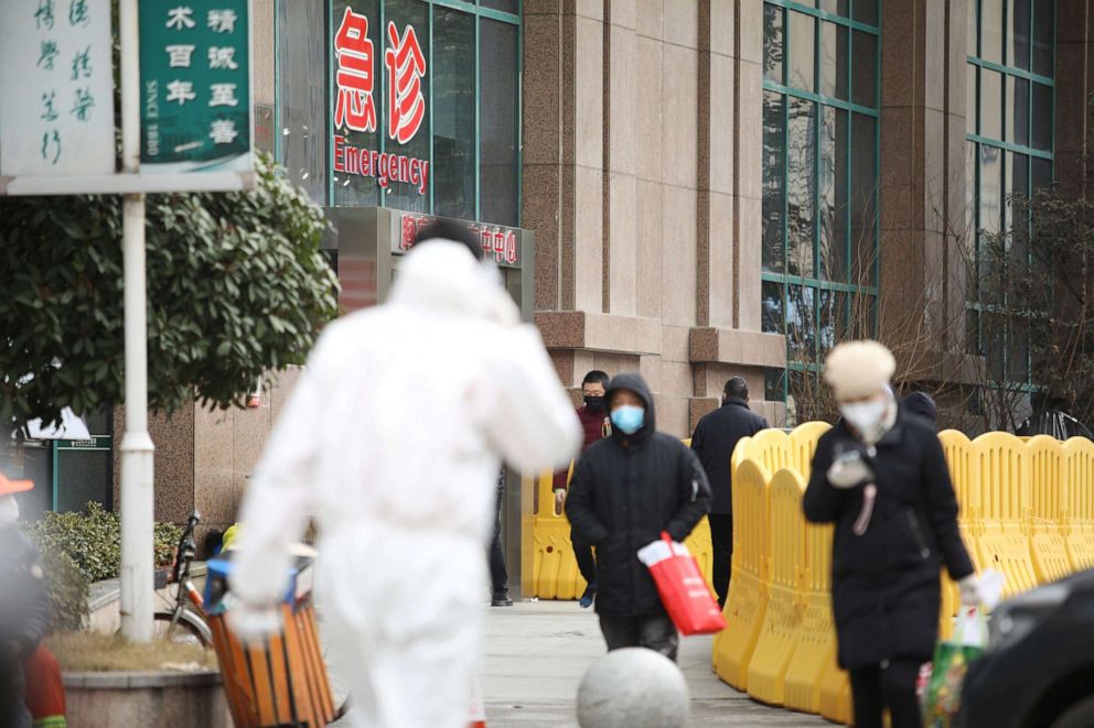 PHOTO: People wearing face masks walk outside Wuhan Central Hospital following an outbreak of the novel coronavirus in Wuhan, Hubei province, China, Feb. 7, 2020.