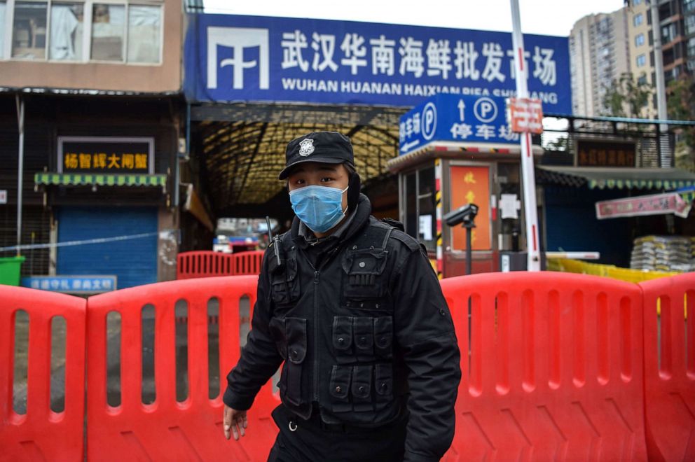 PHOTO: In Jan. 24, 2020, a police officer stands guard outside of Huanan Seafood Wholesale market where the coronavirus was detected in Wuhan, China.