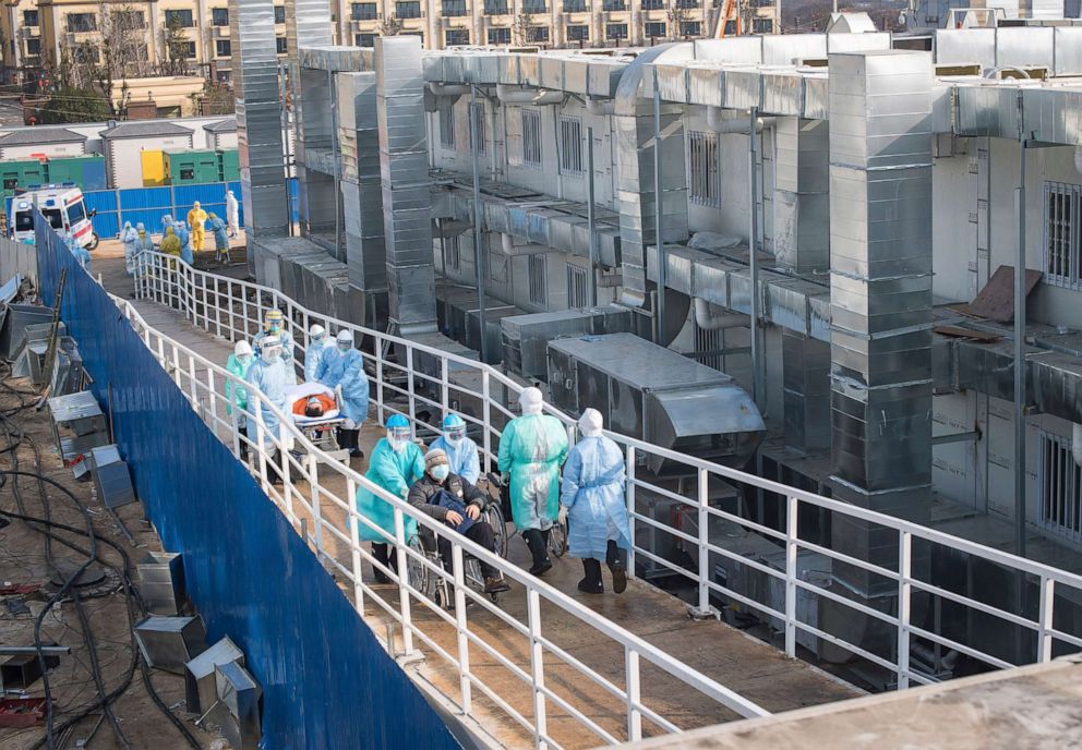 PHOTO: In this photo released by China's Xinhua News Agency, medical workers in protective suits help transfer the first group of patients into the newly-completed Huoshenshan temporary field hospital in Wuhan in central China's Hubei province.