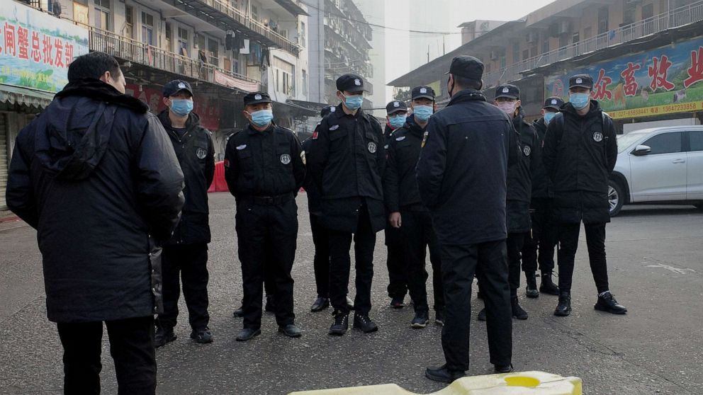 PHOTO: Security guards stand in front of the closed Huanan wholesale seafood market, where health authorities say a man who died from a respiratory illness had purchased goods from, in the city of Wuhan, Hubei province, Jan. 12, 2020.