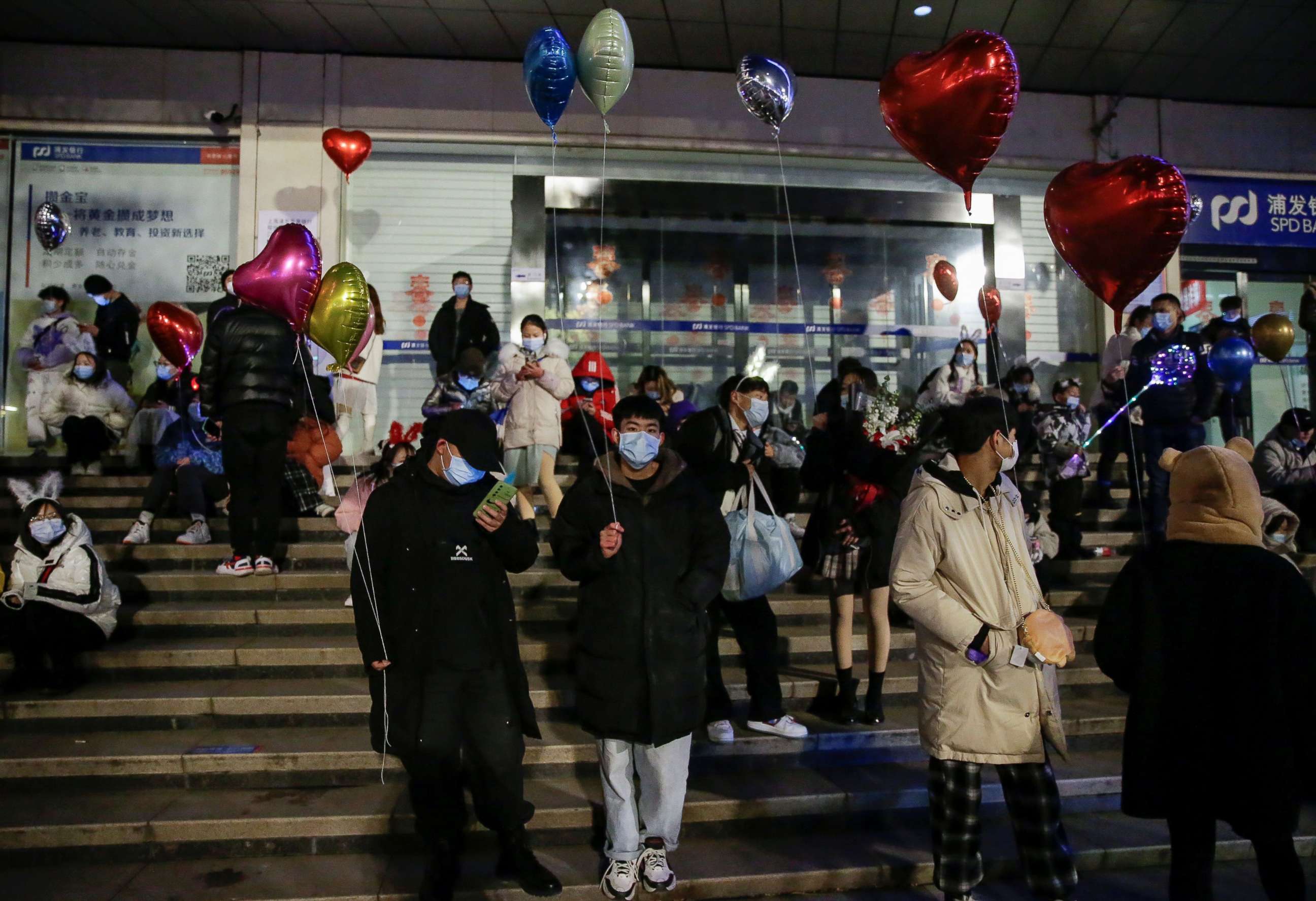 PHOTO: People hold balloons as they gather to celebrate the arrival of the new year during the coronavirus disease (COVID-19) outbreak in Wuhan, China, Dec. 31, 2020.