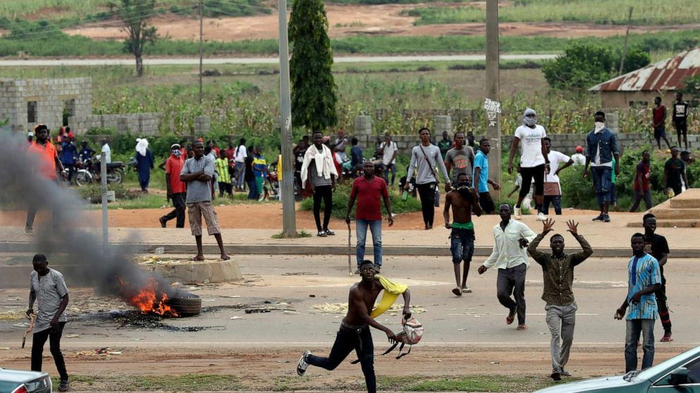 PHOTO: Protesters throw rocks at policemen during an attack on South African business, in Abuja, Nigeria, Sept. 4, 2019.