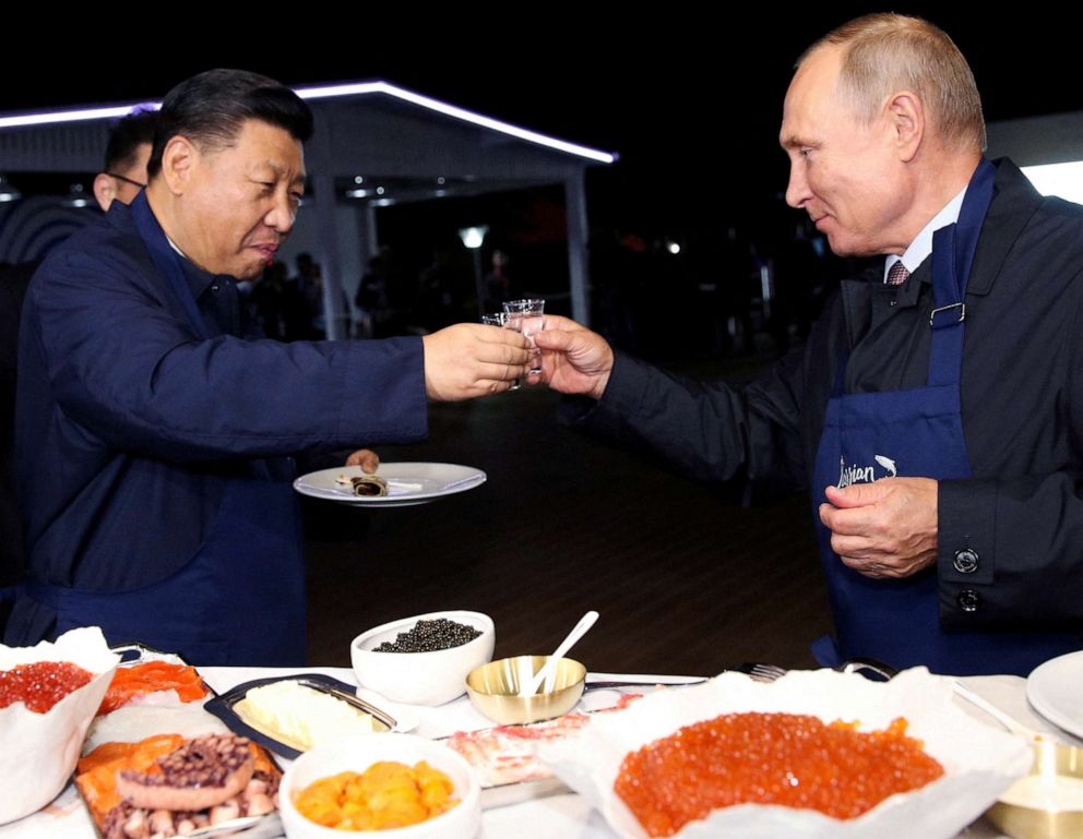 PHOTO: Chinese President Xi Jinping and Russian President Vladimir Putin toast during a visit to the Far East Street exhibition on the sidelines of the Eastern Economic Forum in Vladivostok, Russia, Sept. 11, 2018.