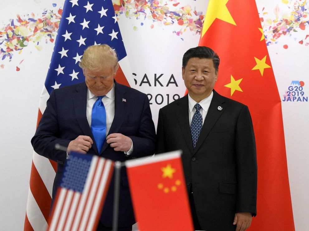 PHOTO: President Donald Trump adjusts his jacket as he poses for a photo with Chinese President Xi Jinping during a meeting on the sidelines of the G-20 summit in Osaka, Japan, Saturday, June 29, 2019.