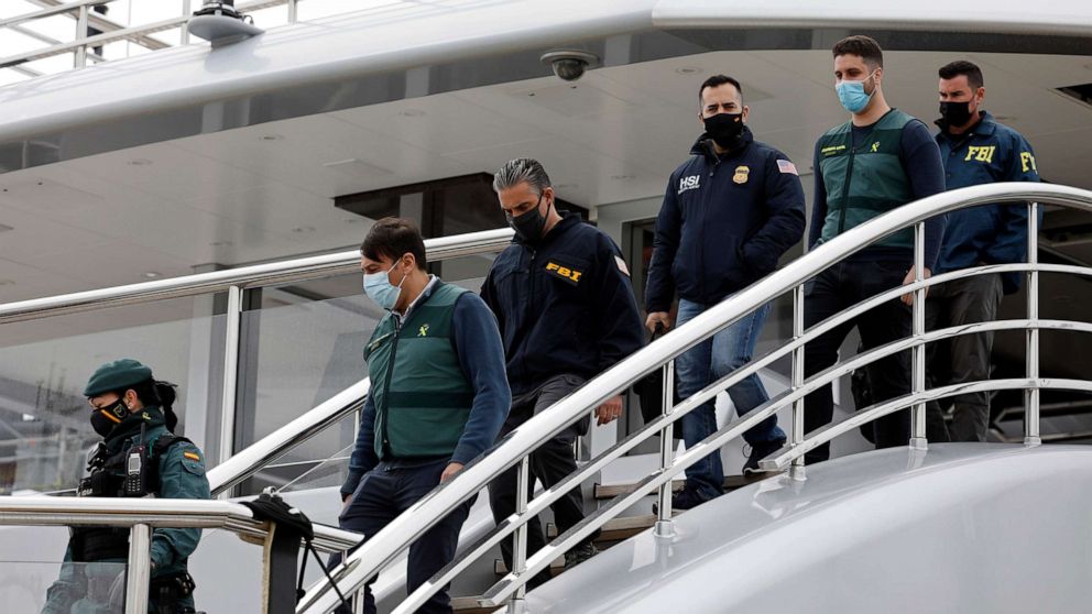 PHOTO: Civil Guards accompany U.S. FBI agents and a U.S. Homeland Security agent from the yacht called Tango in Palma de Mallorca, Spain, April 4, 2022.