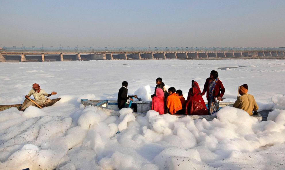 PHOTO: Hindu devotees cross the Yamuna river, surrounded by industrial effluent, on a boat during Karthik Purnima in Delhi, India, Nov. 28, 2012. 