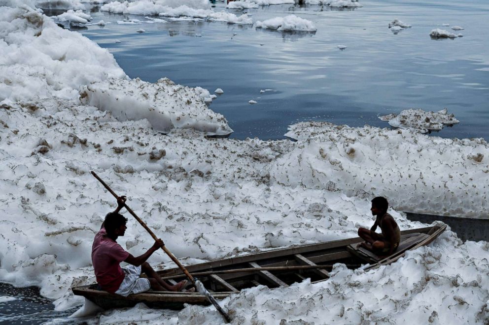 PHOTO: Boys sit in a boat before immersing an idol of Hindu god Lord Ganesh in the polluted Yamuna river on the ninth day of the eleven-day long festival Ganesh Chaturthi in New Delhi on Sept. 21, 2018.