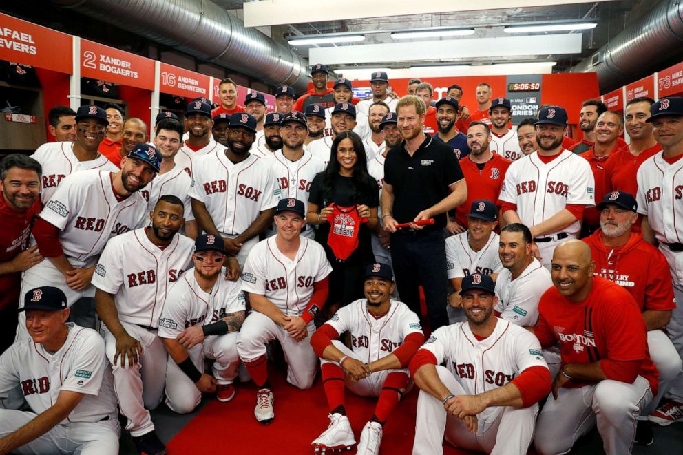 PHOTO: Prince Harry, Duke of Sussex and Meghan, Duchess of Sussex pose for a group photo with the Boston Red Sox before a game against the New York Yankees at London Stadium on June 29, 2019.