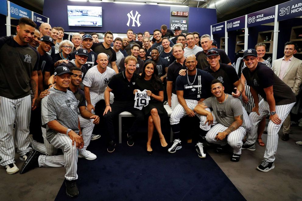 PHOTO: Prince Harry, Duke of Sussex and Meghan, Duchess of Sussex pose for a photo with the New York Yankees before their game against the Boston Red Sox at London Stadium on June 29, 2019.