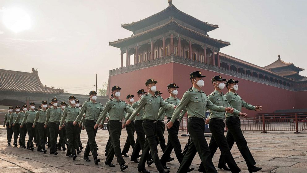 PHOTO: People's Liberation Army soldiers march next to the entrance to the Forbidden City in Beijing on May 21, 2020.