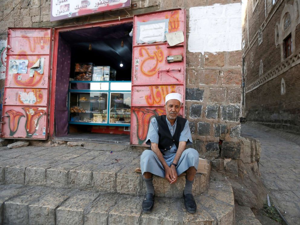 PHOTO: Lutf Ali al-Shahari sits on a pavement in Sanaa, Yemen, March 24, 2018. Life in a time of war is tragedy, injustice, and destruction of houses and roads. Also, food is barely entering the country. Prices are high, he said.
