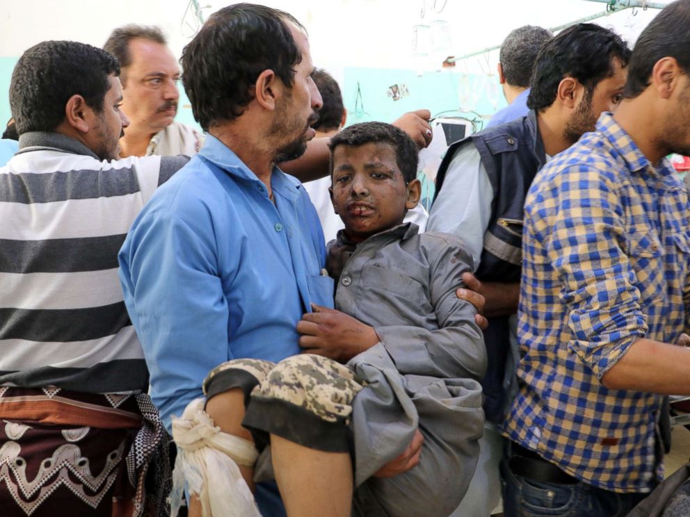 PHOTO: A Yemeni man holds a boy who was injured by an airstrike in Saada, Yemen Aug. 9, 2018.