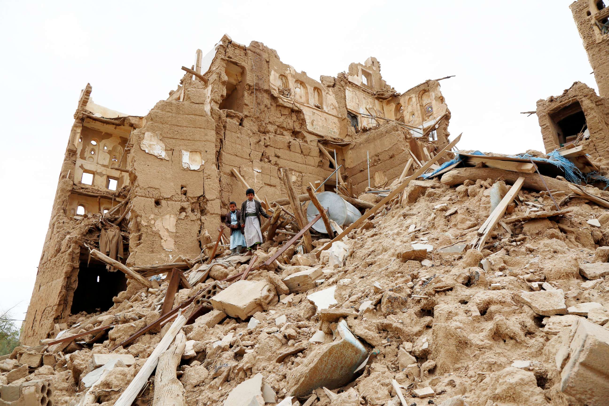 PHOTO:  Children walk on the rubble of houses destroyed by airstrikes during the ongoing conflict in Saada province, Yemen, March 19, 2020.