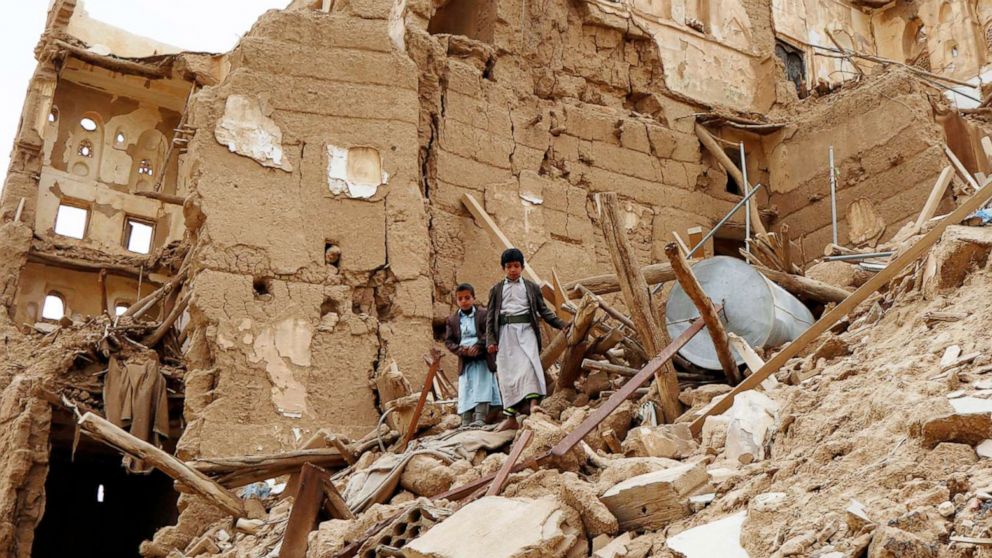 PHOTO:  Children walk on the rubble of houses destroyed by airstrikes during the ongoing conflict in Saada province, Yemen, March 19, 2020.