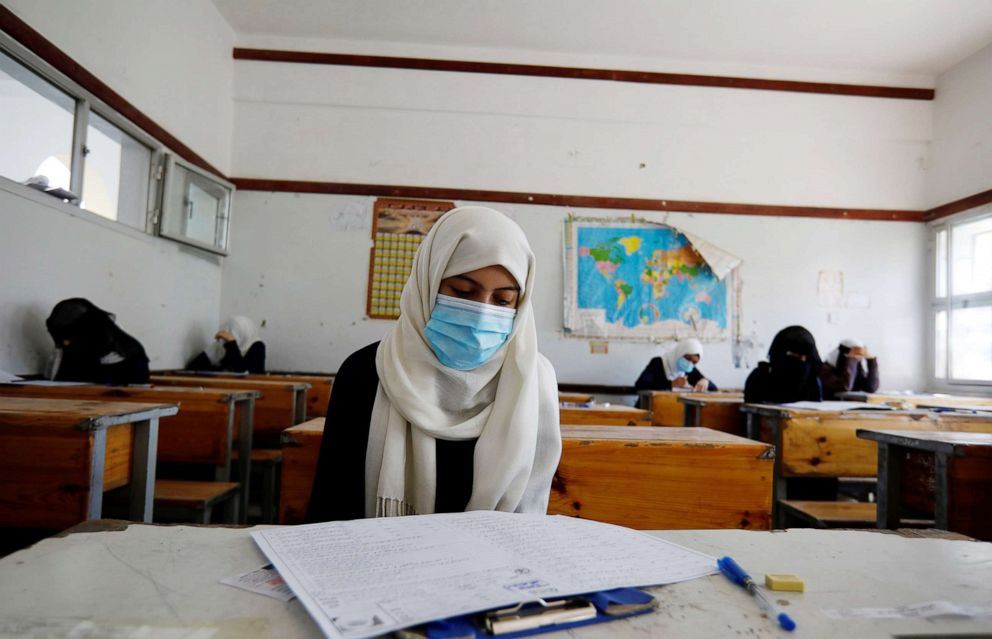 PHOTO: Students wearing protective face masks take final exams at a public school in Sana'a, Yemen, Aug. 15, 2020.