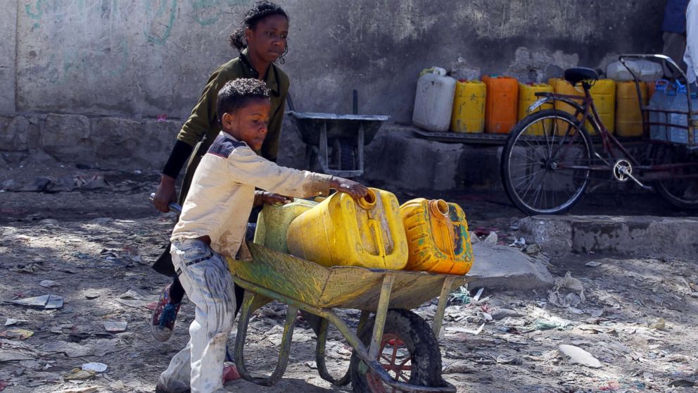 PHOTO: Yemeni children push a wheelbarrow with jerrycans filled with drinking water from a donated water pipe in Sana'a, Yemen, Nov. 18, 2017. 