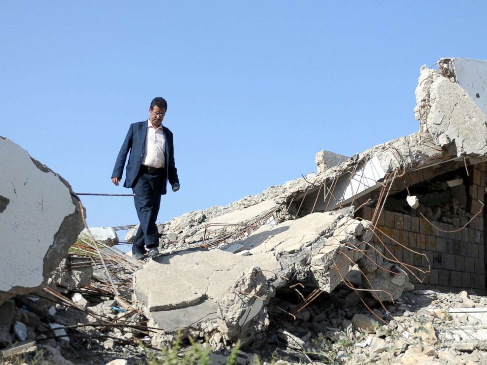 PHOTO: A Yemeni teacher walks through the debris of a public school bombed by Saudi-led air strikes, on the first week of a new school year in Ibb, Yemen, Oct. 18, 2017.