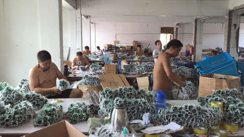 Factory workers in Yiwu, China assemble Christmas trees for the upcoming holiday.