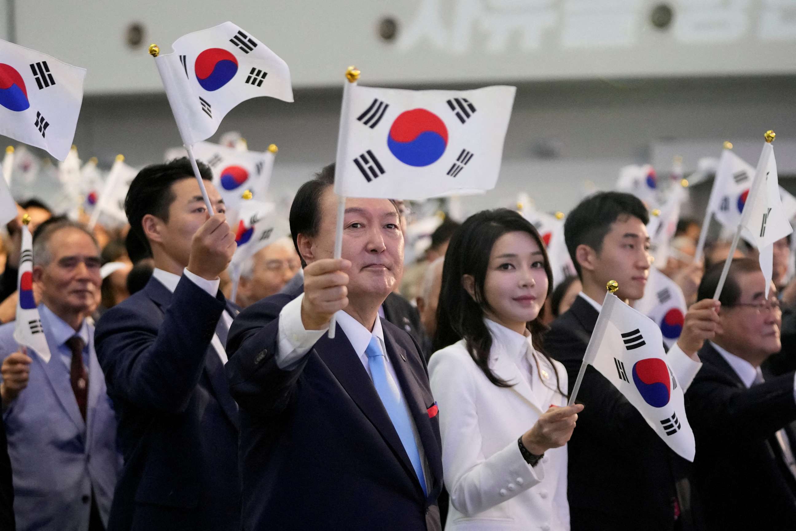 FILE PHOTO: South Korean President Yoon Suk Yeol and his wife Kim Keon Hee wave the national flag during a ceremony to celebrate the 78th anniversary of the Korean Liberation Day from Japanese colonial rule in 1945, in Seoul, South Korea, Aug. 15, 2023.