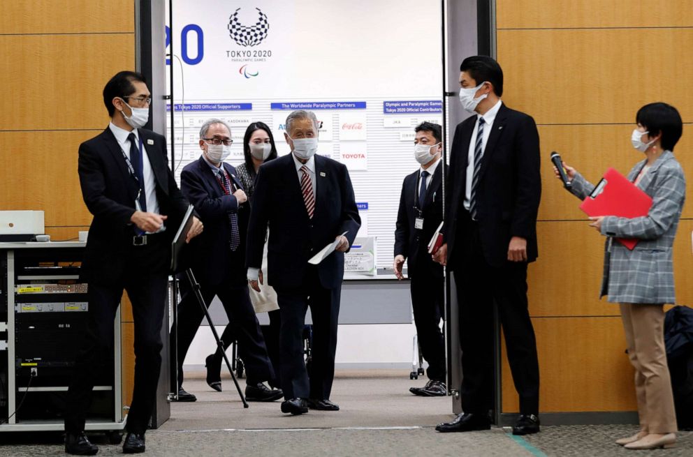 PHOTO: Yoshiro Mori, center, president of the Tokyo Olympics organizing committee, enters a venue for a news conference in Tokyo, Japan, on Feb. 4, 2021.