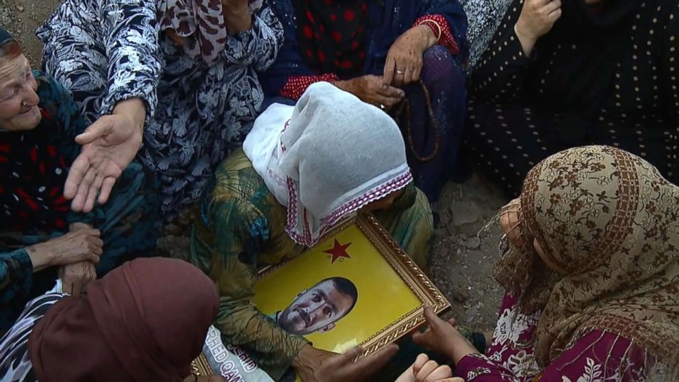 PHOTO: Soldiers and loved ones mourn the loss of the dead.