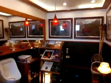 VIDEO: This Shell gas station in the Philippines features wood-paneled counters, a magazine stand and paintings hanging on the walls.