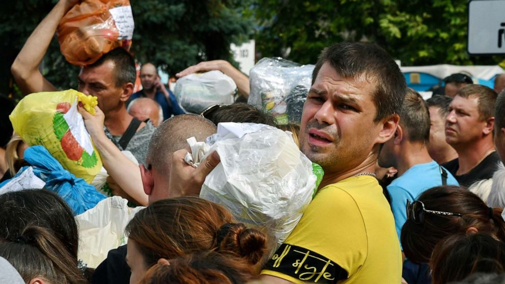 PHOTO: Residents, many of whom fled the war, bring items such as medicine, clothes and other personal care items, to be transported by volunteers to their relatives in areas controlled by Russia, in Zaporizhzhia, Ukraine, Aug. 14, 2022.