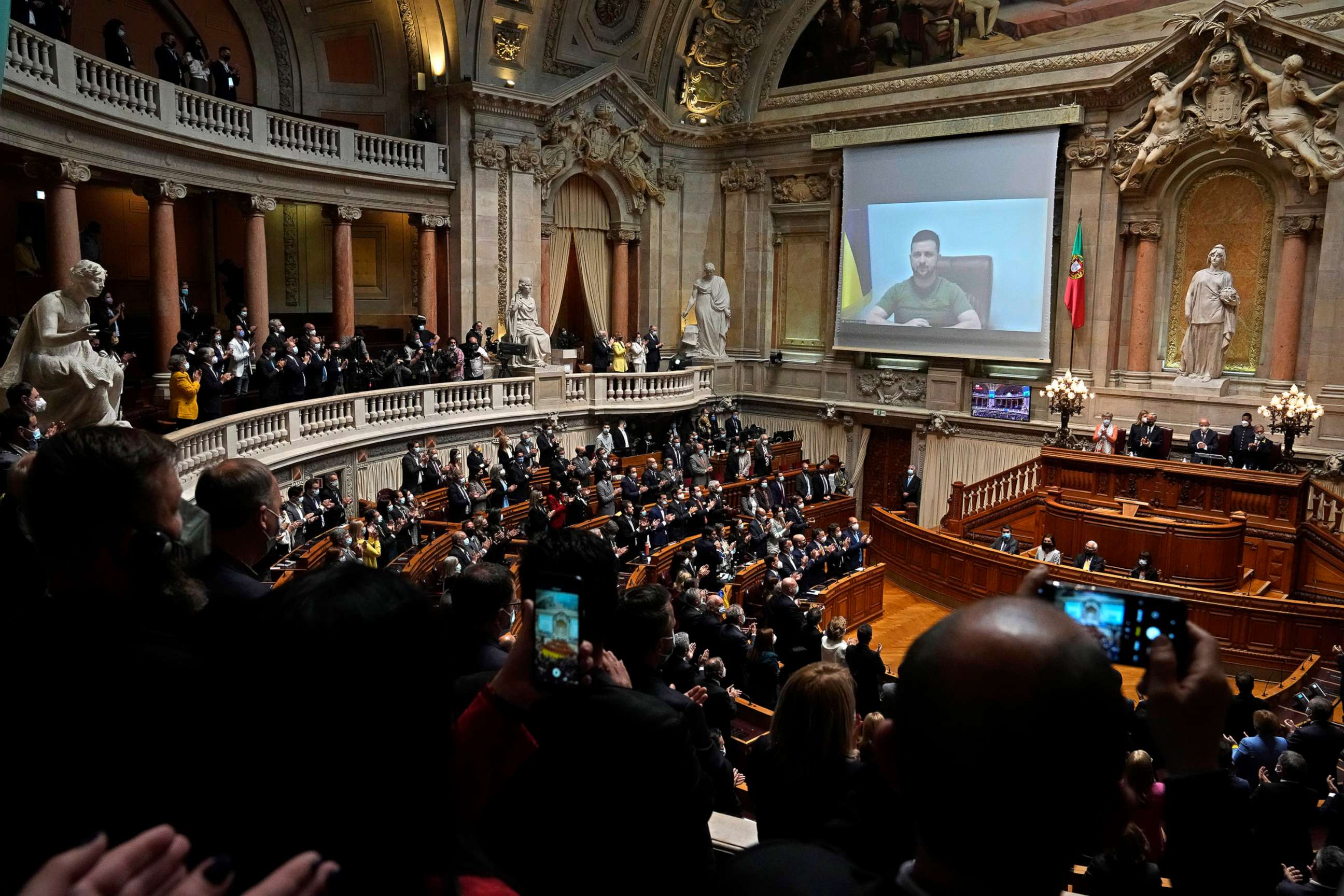 PHOTO: Members of Parliament and guests stand and applaud the speech of Ukrainian President Volodymyr Zelenskyy, after his address to the Portuguese parliament in Lisbon, via video conference, April 21, 2022.