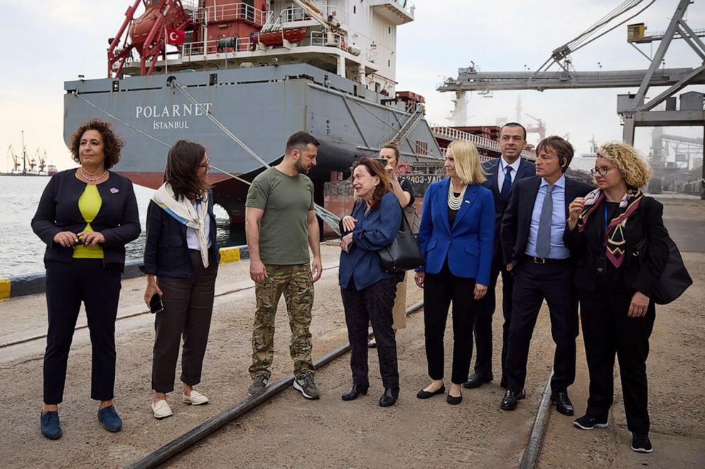 PHOTO: Ukrainian President Volodymyr Zelenskyy, third from left, is surrounded by U.N. officials and ambassadors of different countries, as they visit a port in Chornomork, near Odesa, southwestern Ukraine, on July 29, 2022.