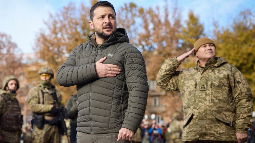 PHOTO: In this photo provided by the Ukrainian Presidential Press Office, Ukrainian President Volodymyr Zelenskyy listens to the national anthem during his visit to Kherson, Ukraine, Nov. 14, 2022.