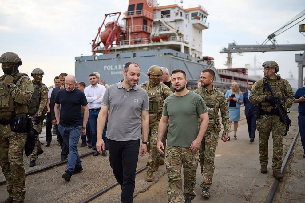 PHOTO: Ukrainian President Volodymyr Zelenskyy, center right, and Ukrainian Minister of Infrastructure Oleksander Kubrakov, center left, visit a port in Chornomork, near Odesa, southwestern Ukraine, on July 29, 2022, as a ship is loaded with grain.