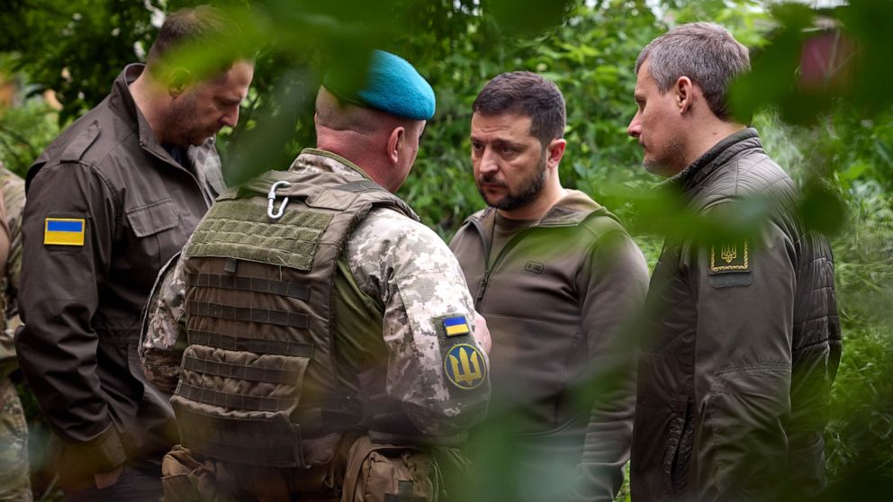 PHOTO: In this photo provided by the Ukrainian Presidential Press Office, Ukrainian president Volodymyr Zelenskyy, second right, listens to military commander as he visits the Donetsk region, Ukraine, May 23, 2023.