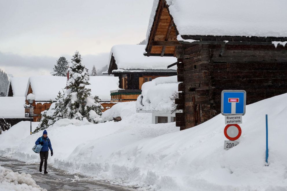 PHOTO: A pedestrian walks in the small resort of Zinal, Swiss Alps, Jan. 9, 2018, after the access road cut by heavy snowfall reopened.