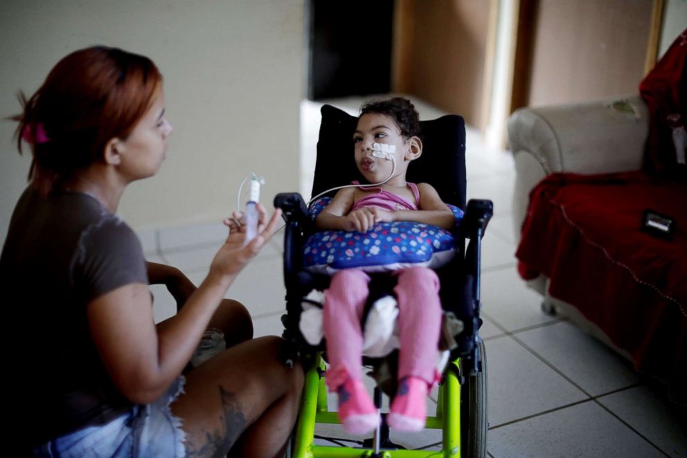 PHOTO: Rosana Vieira Alves, 28, feeds her two-year-old daughter Luana Vieira, who was born with microcephaly, at their house in Olinda, Brazil, Aug. 9, 2018.