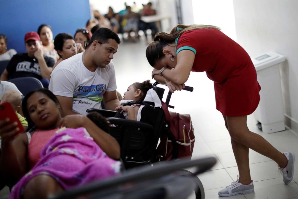 PHOTO: Gleyse Kelly da Silva, 28, rests on the baby carriage of her two-year-old daughter Maria Giovanna, while waiting for a medical appointment in a hospital in Recife, Brazil, Aug. 8, 2018.