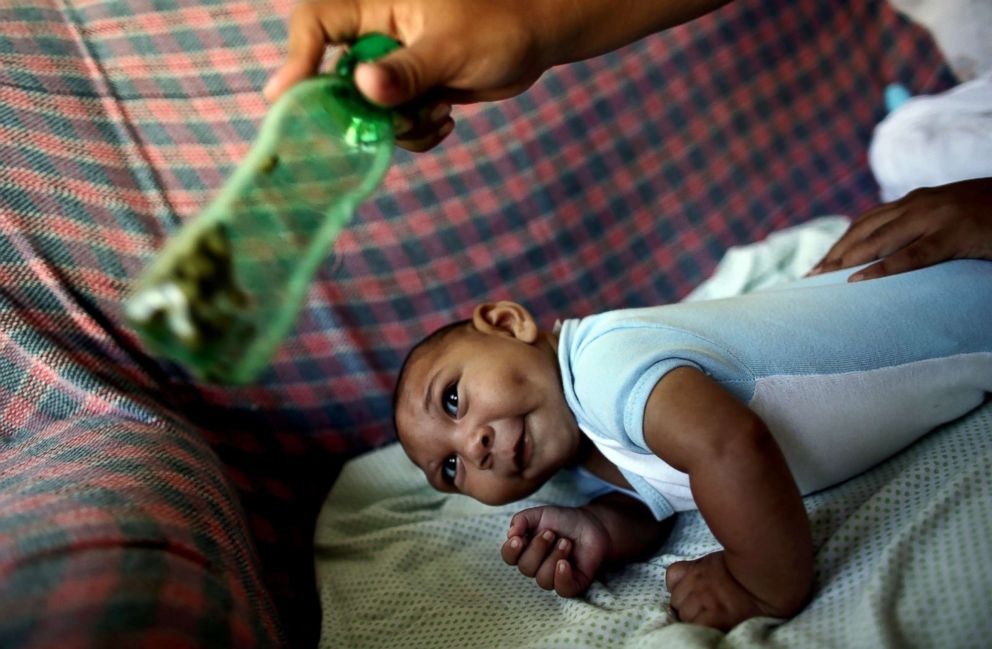 PHOTO: Jackeline Vieira de Souza, 26, uses a green bottle to stimulate her four-month-old son Daniel who was born with microcephaly inside their house in Olinda, near Recife, Brazil, Feb. 11, 2016.