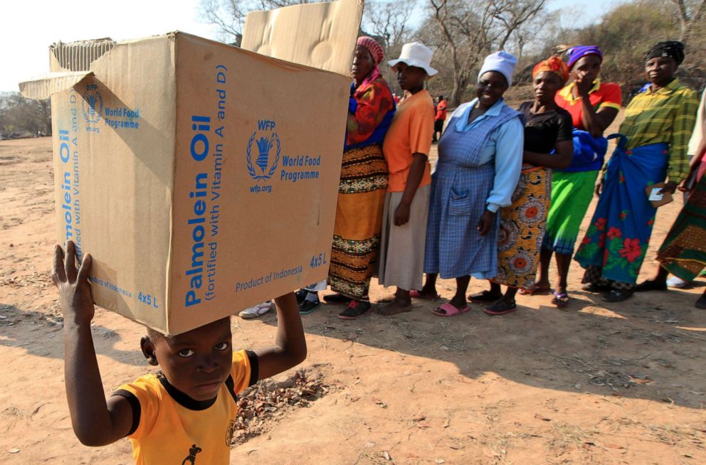 PHOTO: In this Sept. 9, 2015 file photo, a child carries a parcel from the United Nations World Food Program in Mwenezi, Zimbabwe.