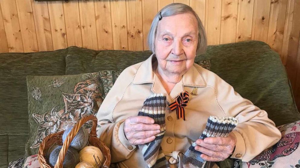PHOTO: Zinaida Korneva, a Russian veteran of World War II, holds a pair of socks she knitted for Capt. Tom Moore, a British veteran of World War II.