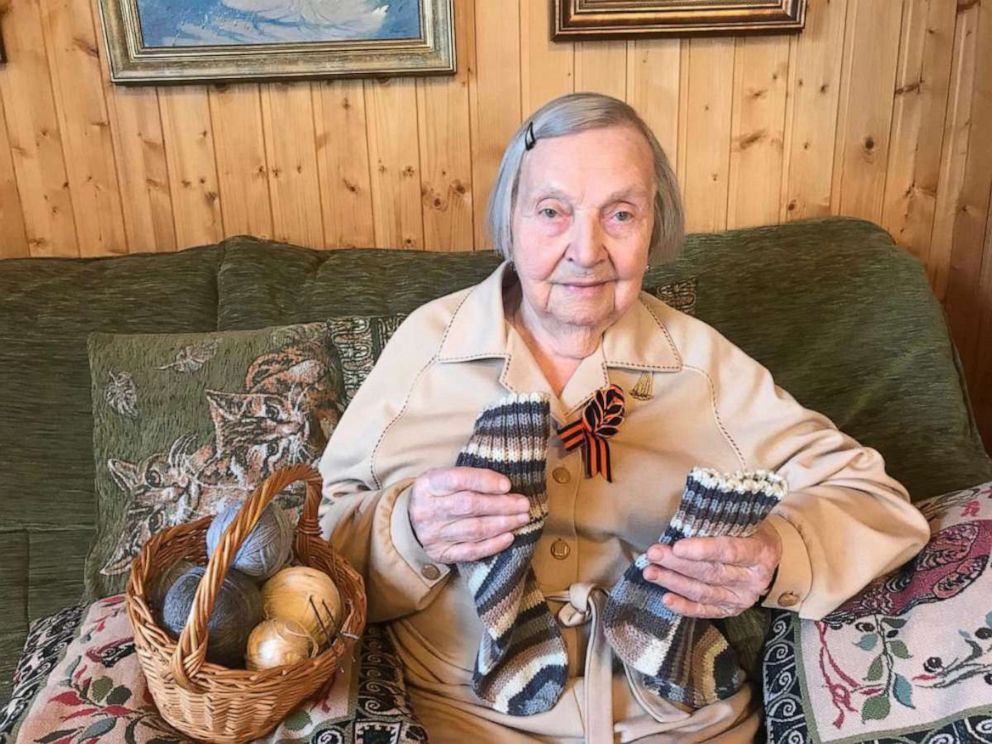 PHOTO: Zinaida Korneva, a Russian veteran of World War II, holds a pair of socks she knitted for Capt. Tom Moore, a British veteran of World War II.