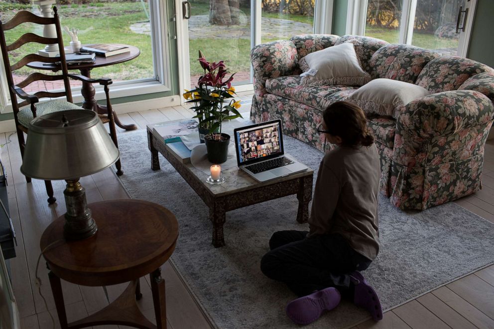 PHOTO: A family sits for shiva, a traditional Jewish time of mourning for the dead when friends and family gather, remotely on zoom for an elderly relative who died of heart failure, April 11, 2020, in New Canaan, Conn.