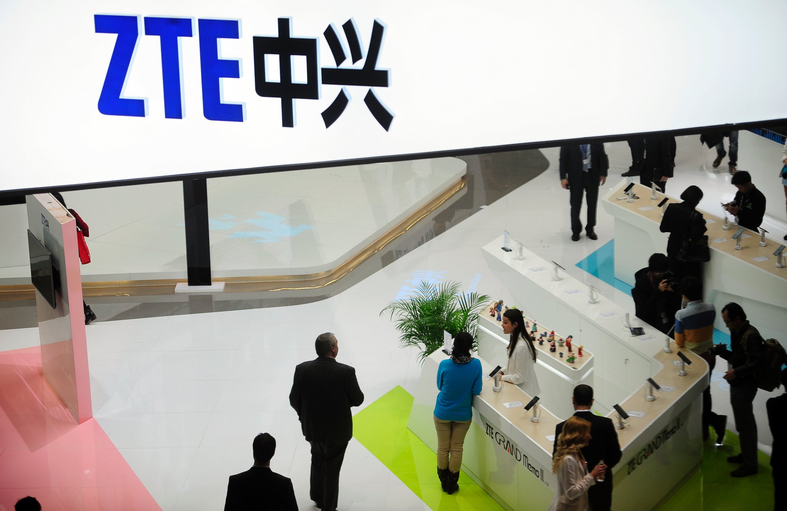 In this Wednesday, Feb. 26, 2014, file photo, people gather at the ZTE booth at the Mobile World Congress, the world's largest mobile phone trade show in Barcelona, Spain.