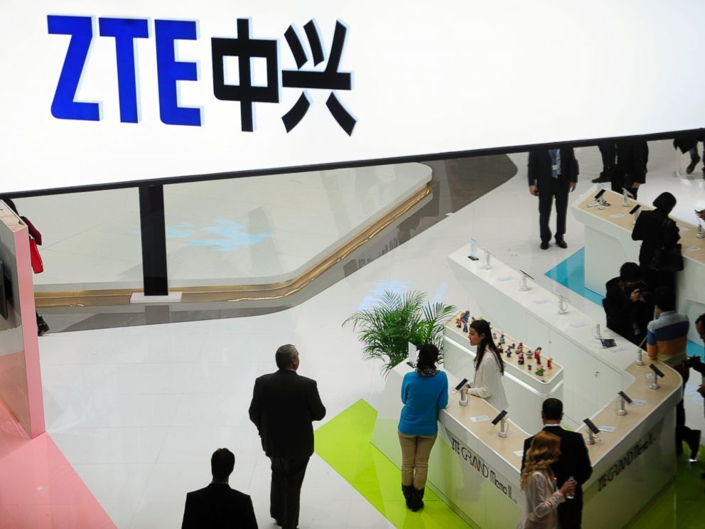In this Wednesday, Feb. 26, 2014, file photo, people gather at the ZTE booth at the Mobile World Congress, the worlds largest mobile phone trade show in Barcelona, Spain.
