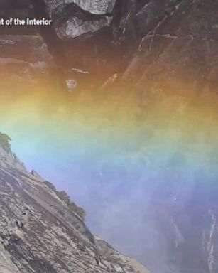 Water and sunlight combine at Yosemite Falls, creating a majestic rainbow and mesmerizing display at Yosemite National Park.